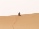 Ramlat Assayef - Tuareg sitting on the sand dunes